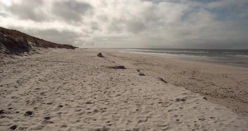 West beach of Sylt on a sunny day with kite surfers on the sea