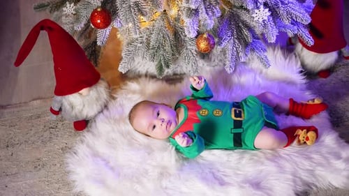 Green elf costume put on adorable little child.