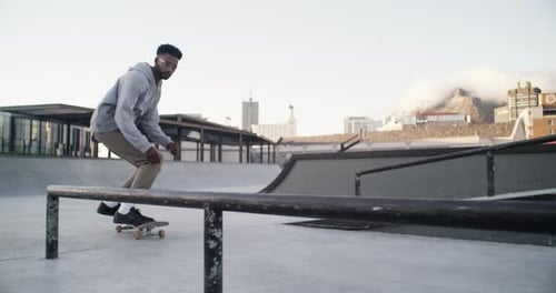4k video footage of an unrecognizable young man out skating at a skatepark