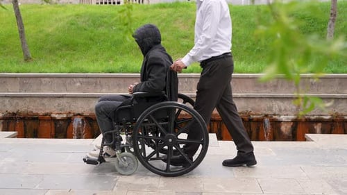 Disabled man in a wheelchair and his brother