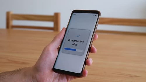 Downloading files with your smartphone. Concept of piracy through mobile apps.
