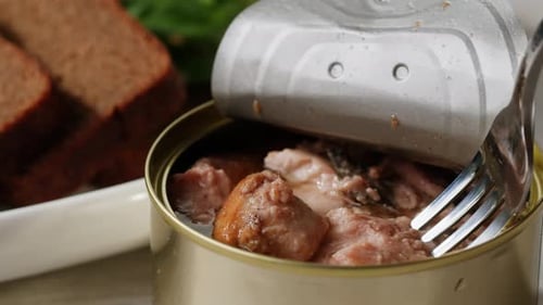 Canned Sardines Being Lifted By Fork Close-Up