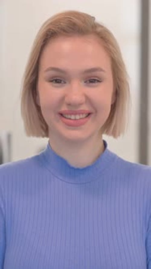 Portrait of Smiling Young Woman in Office, vertical video