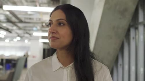 Businesswomen Walking And Talking In Office Corridor
