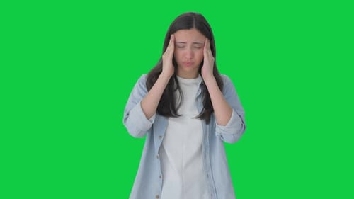 Indian girl having a headache Green screen