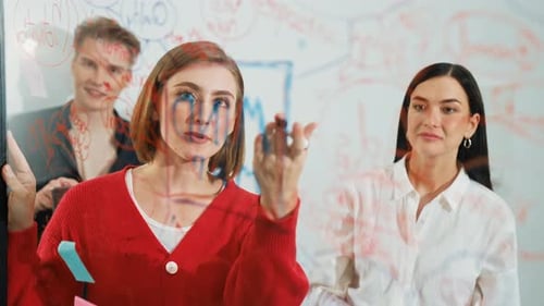 Three Colleagues Brainstorming Together in a Modern Office Space