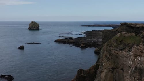 Dark basalt cliffs at shore of Iceland Valahnúkamöl area, aerial