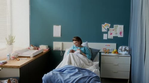 New Mother Bonding With Newborn in Hospital