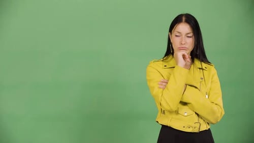 A Young Beautiful Caucasian Woman Thinks About Something Green Screen Studio