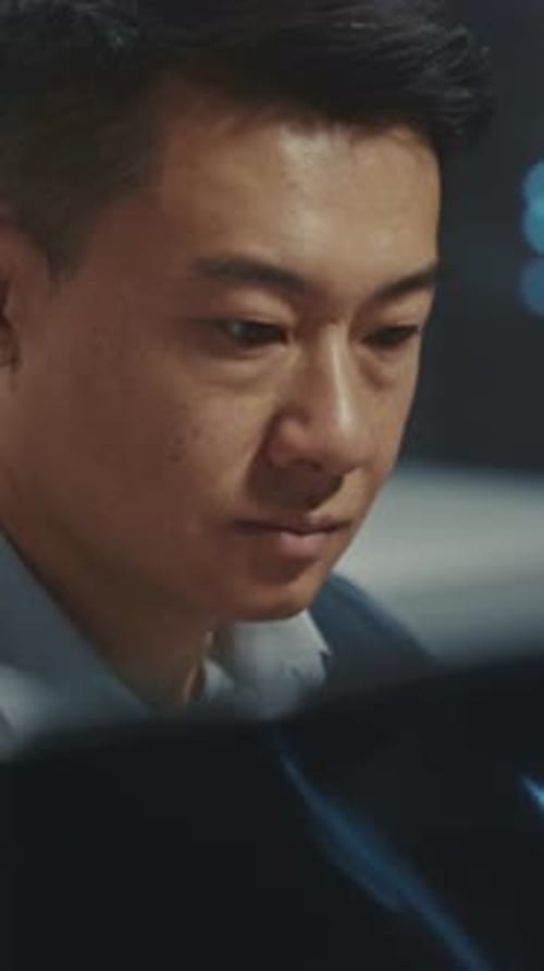 Man Working at Computer in Dark Office