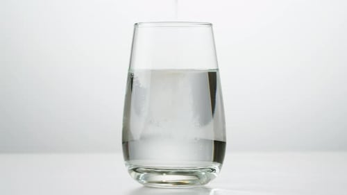 Powder Mixes into Water in a Glass