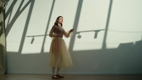Graceful Ballerina Performing Classical Ballet Dance in a Sunny Studio