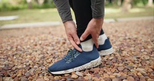 Running, joint pain and shoes of person in park for fitness, first aid and sports injury