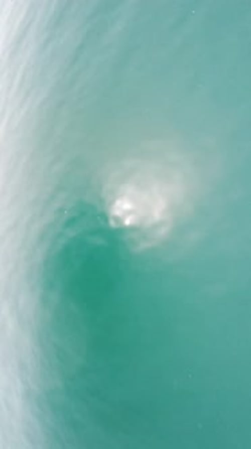 Vertical Aerial View on Sea Water Surface Camera Flies Over Clear Sea Water Sun Glare Abstract