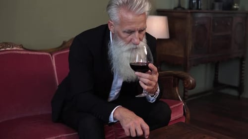 Senior Man With White Beard Drinking Wine