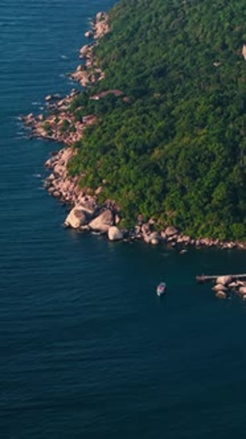 Lush Tropical Vegetation Covers the Rocky Coastline of the Island of Koh Tao in Thailand with