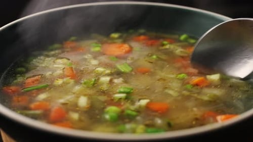 Homemade Chicken Vegetable Soup Cooking Close Up View of Chef Cooking Vegan Healthy Soup in Big Pan