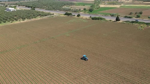 Agriculture field with tractor.