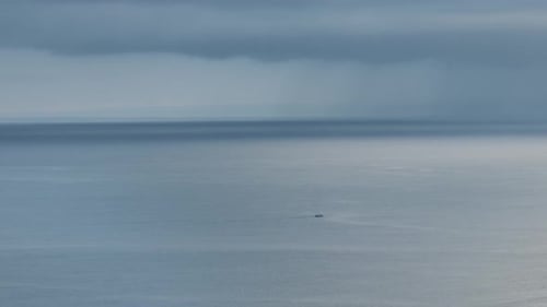 Small boat in front of dark clouds in the pacific. Bali - Indonesia.
