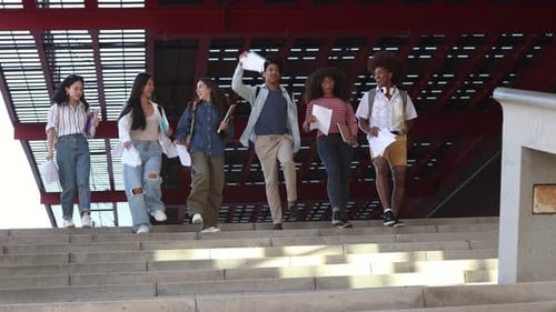 Students Descend Stairs to Celebrate Graduation