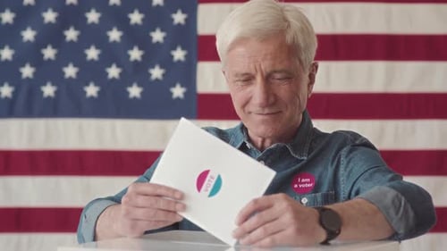 Smiling Man Voting with American Flag Background