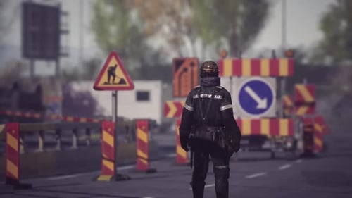 Construction Worker Managing Traffic on a Busy Road During Daytime