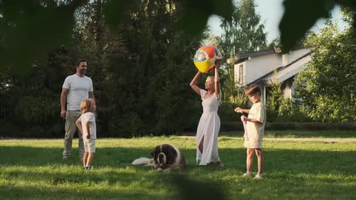 Family Plays Ball with Dog in Suburban Yard