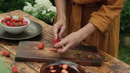 Woman Slices Fresh Strawberries Outside in Summer