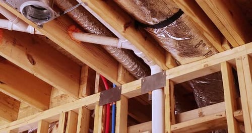 Home Under Construction Shows Framing and Ductwork