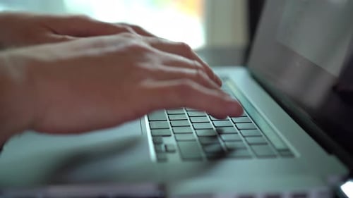 Hands on laptop keypad using technology from home businessman office