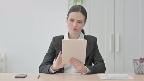 Young Businesswoman using Digital Tablet for Work