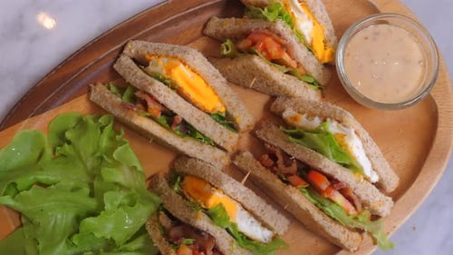 Delicious Club Sandwiches with Eggs Bacon Lettuce and Tomato on