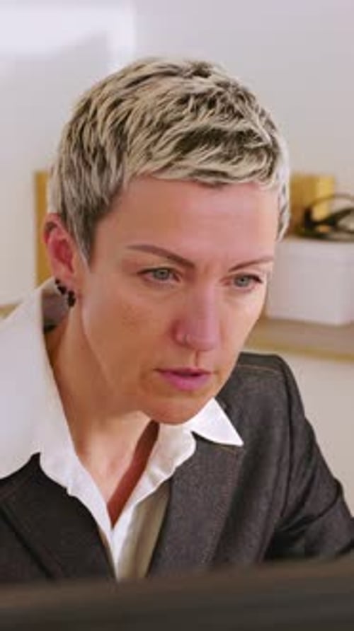 Middle Aged Businesswoman Working on Desktop PC in the Office