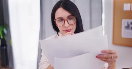 Confident Businesswoman Analyzes Financial Documents
