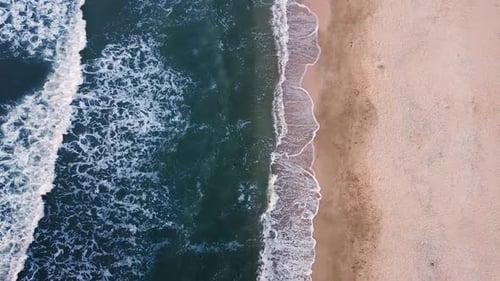 Ocean Meets Sand Striking Aerial View of Waves on Beach