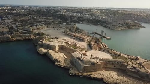 Aerial view of Valetta, Malta. Tilt up revealing Fort Rinella.