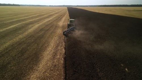 Tractors plowing the field in Ukraine