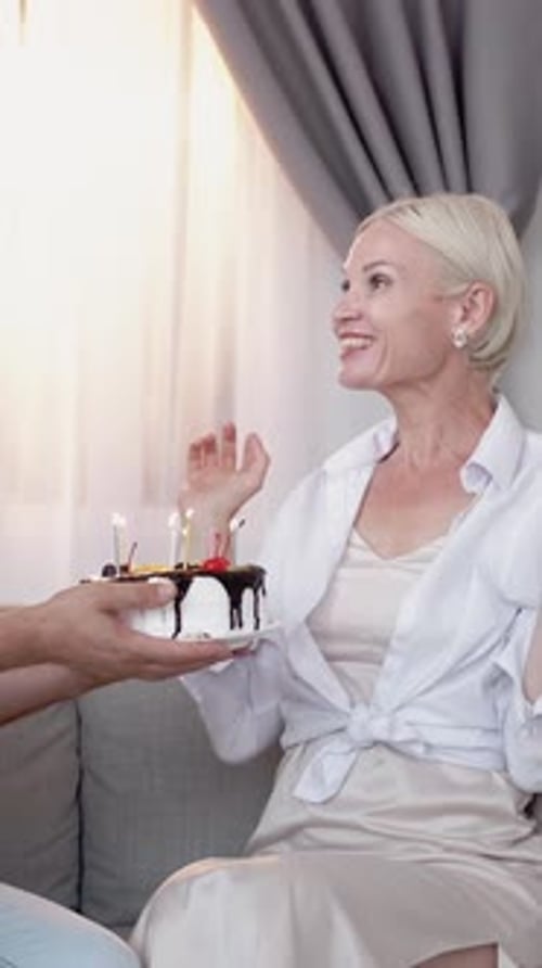 Woman Surprised With Birthday Cake Indoors