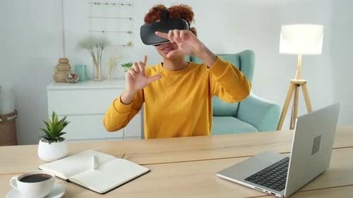 Woman Experiencing Virtual Reality Headset at Desk