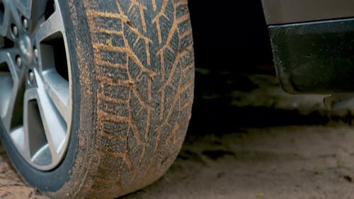 Wheel of Car Slip on Sand Dirt Road During Start of Movement Close Up