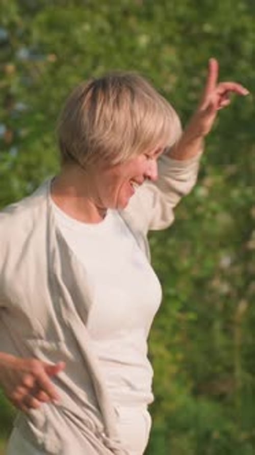 Pet Lover Dancing Joyfully in Sunny Garden Surrounded By Trees and Nature