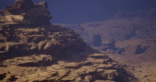 Unique Rock Formations in a Desolate Landscape Under a Deep Blue Sky