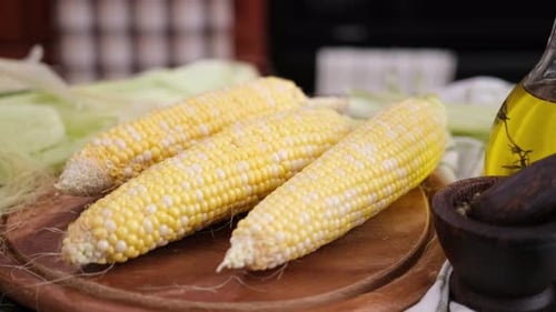 Fresh Yellow Corn Still Life on Cutting Board