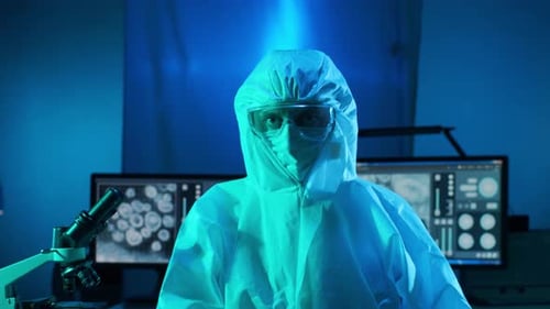Scientist in Lab Wearing Protective Suit and Mask