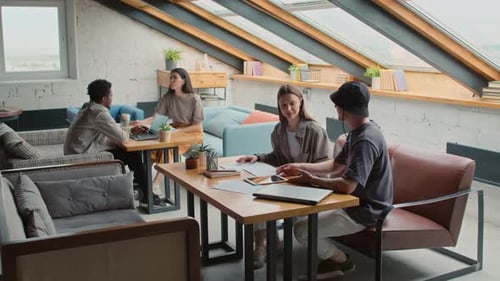 Diverse Freelancers Talking in Loft Coworking Office