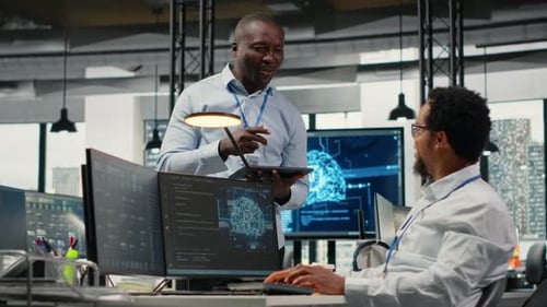 Smiling Programmers Working in AI Startup Train Predictive Models