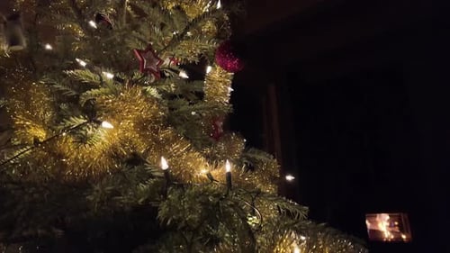 Festive Christmas Tree with Warm Lights at Night