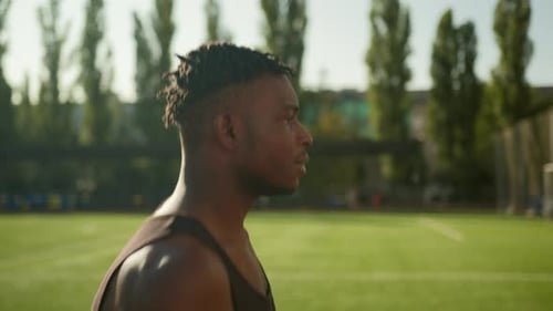 African American Runner Jogger Sportsman Running on Sports Track Outdoor Stadium Motivated Fitness