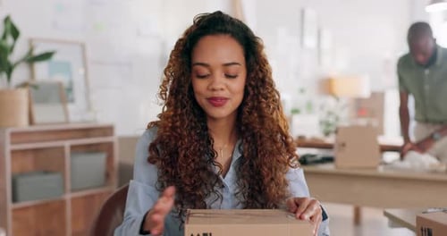 Woman Packages Box in Workplace