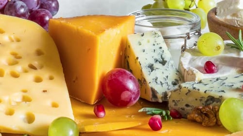 Assortment Cheeses on Wooden Cutting Board Cheese Plate Served with Grape Fruits Pomegranate